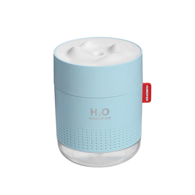 White cylindrical USB charging desktop humidifier with a clear base and a textured snow mountain top. Features 'H₂O HUMIDIFIER' text and a red tag. - Image 7