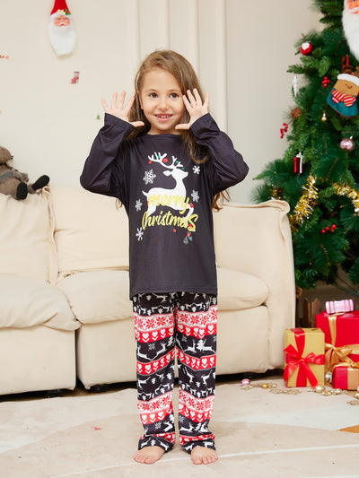 Two children wearing black long-sleeve Christmas pajamas with a "Merry Christmas" reindeer design and fair isle pants. - Image 7