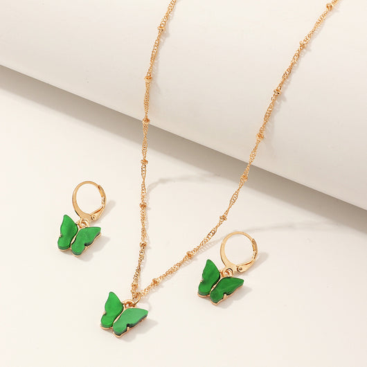 Blue resin butterfly necklace and earring set with gold-tone chains and findings, displayed on a light background. - Image 5