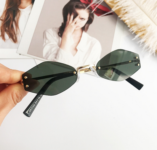 Retro oval vintage sunglasses with orange hexagonal lenses and gold-tone metal temples, held by a hand. - Image 6