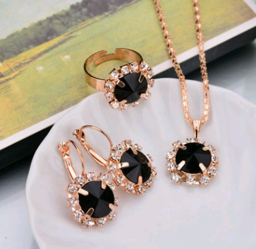 Rose gold-toned necklace, earrings, and ring set with large oval clear gemstones surrounded by smaller stones. - Image 20