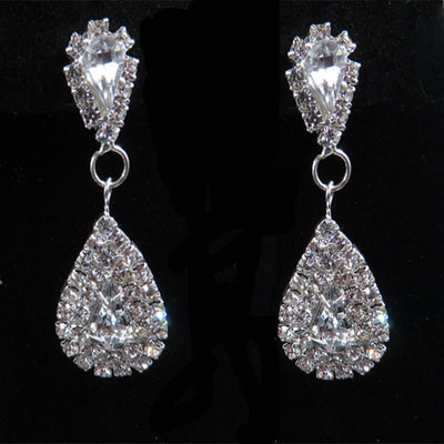 Sparkling silver-tone bridal jewelry set with a rhinestone necklace and matching teardrop drop earrings on a black bust. - Image 5