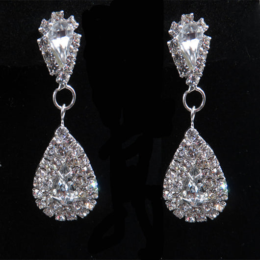 Sparkling silver-tone bridal jewelry set with a rhinestone necklace and matching teardrop drop earrings on a black bust. - Image 5