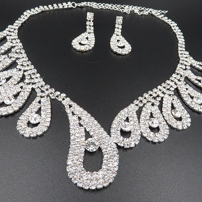 Silver-toned rhinestone necklace and matching drop earrings set with iridescent accents, ideal for bridal or formal wear. - Image 7