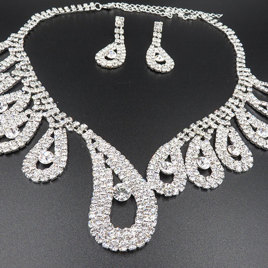 Silver-toned rhinestone necklace and matching drop earrings set with iridescent accents, ideal for bridal or formal wear. - Image 7