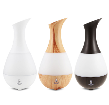 White teardrop-shaped aromatherapy humidifier with a curved neck and a power button, featuring a translucent middle section.