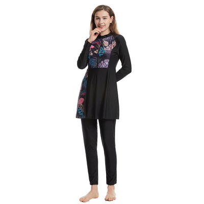 Woman in a navy blue quick-drying conservative swimwear set with a tropical leaf print tunic and matching swim cap. - Image 12