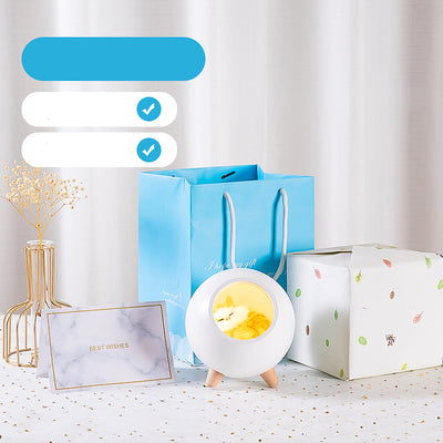 Pink spherical sleeping light with a sleeping cat design, wooden legs, and soft glow, displayed with gift packaging. - Image 6