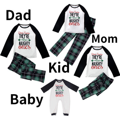 Family matching Christmas pajamas with "Dear Santa They're the Naughty Ones" print and green plaid pants.