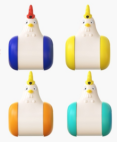 White and yellow chicken-shaped tumbler cat toy with a laser pointer, being played with by two orange tabby cats. - Image 15