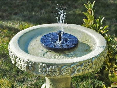 5W solar fountain kit with black solar panel on a ground stake, water pump, coiled hose, and various nozzles. - Image 15