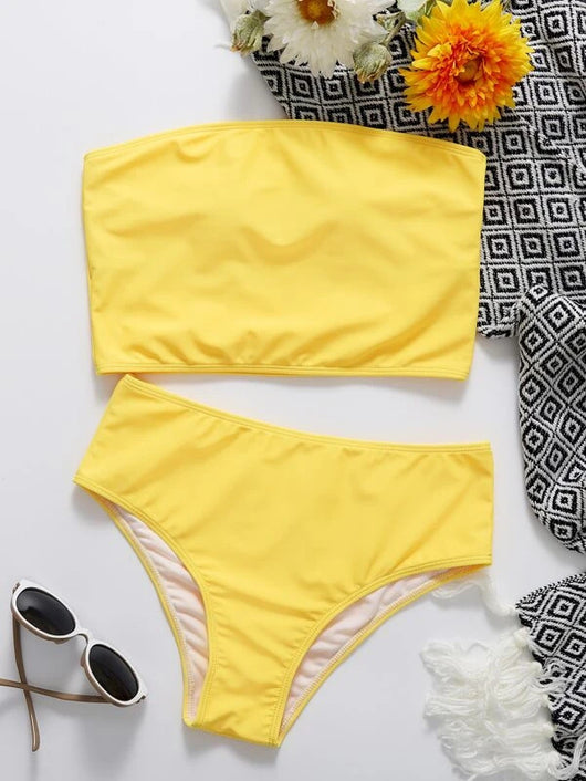 Vibrant orange strapless bandeau bikini top and high-waisted bottoms set, worn by a woman with a white shirt. - Image 24