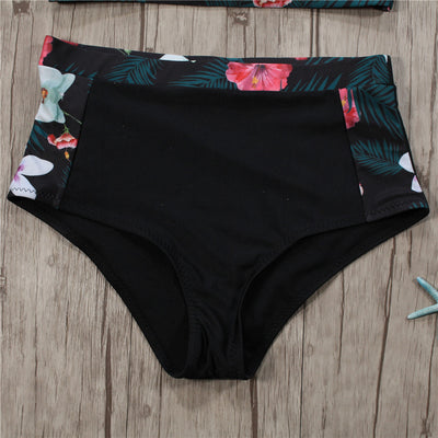 Black high-neck halter bikini top and high-waisted bottoms with pink and white floral leaf print. - Image 2