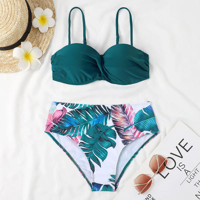 Teal twisted bandeau bikini top with tropical leaf print high-waisted bottoms on a model wearing a white shirt. - Image 21