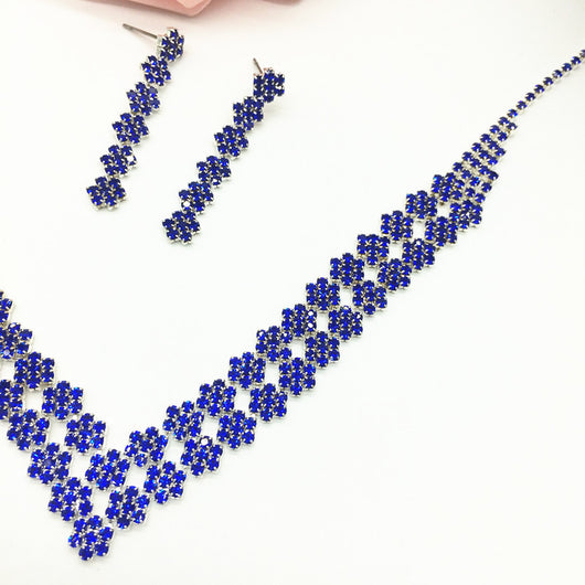 Sparkling silver-tone rhinestone necklace and matching dangle earrings set, featuring a V-shaped design on a black bust. - Image 2