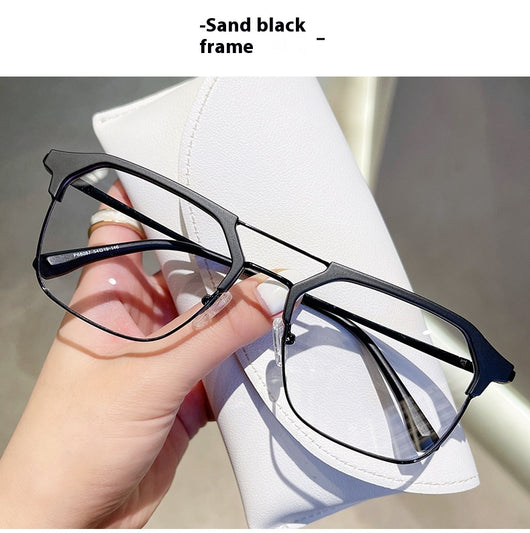 Anti-blue light glasses with a sand black and silver double beam frame, held against a white case. - Image 26