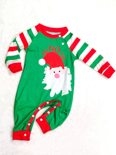 Woman wearing a green, red, and white striped Christmas pajama set with a Santa Claus graphic on the top. - Image 3