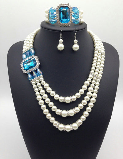 Three-piece jewelry set with multi-strand pearl necklace, blue gemstone pendant, matching pearl drop earrings, and pearl bracelet. - Image 5