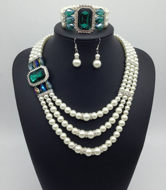 Three-piece jewelry set with multi-strand pearl necklace, blue gemstone pendant, matching pearl drop earrings, and pearl bracelet. - Image 3