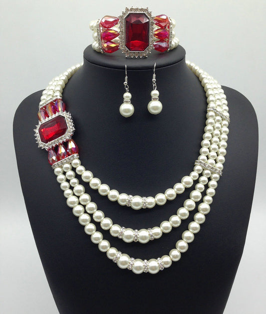 Three-piece jewelry set with multi-strand pearl necklace, blue gemstone pendant, matching pearl drop earrings, and pearl bracelet. - Image 2