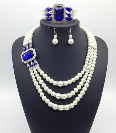 Three-piece jewelry set with multi-strand pearl necklace, blue gemstone pendant, matching pearl drop earrings, and pearl bracelet. - Image 7