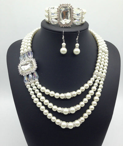 Three-piece jewelry set with multi-strand pearl necklace, blue gemstone pendant, matching pearl drop earrings, and pearl bracelet. - Image 6
