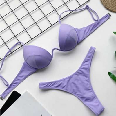 White two-piece bikini set with a push-up top and thong bottom, made of polyester, laid flat on a white surface. - Image 10