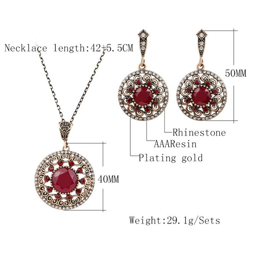 Vintage-style jewelry set with a necklace and matching drop earrings. Features red and clear gemstones in an antique gold-tone filigree design. - Image 5