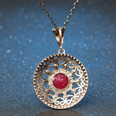 Vintage-style jewelry set with a necklace and matching drop earrings. Features red and clear gemstones in an antique gold-tone filigree design. - Image 3