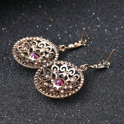 Vintage-style jewelry set with a necklace and matching drop earrings. Features red and clear gemstones in an antique gold-tone filigree design. - Image 4