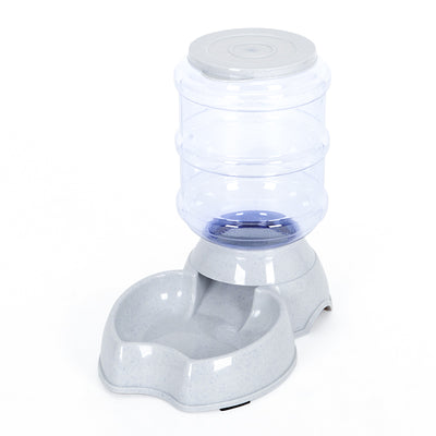 White pet feeding station with a stainless steel food bowl and a clear automatic water dispenser bottle. - Image 17