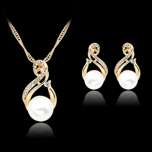 Gold-tone necklace and matching earrings set with white faux pearls and clear rhinestones, ideal for bridal or dinner wear.