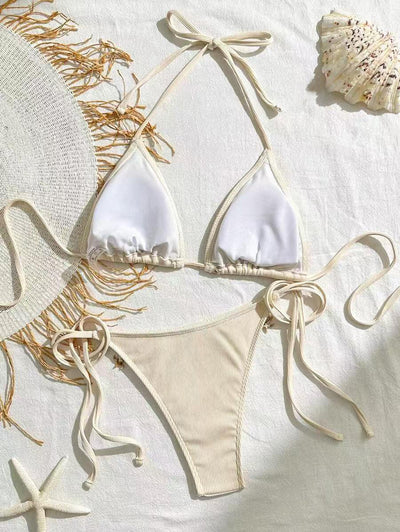 Light pink ribbed halterneck bikini with triangle cups and tie-side bottom, adorned with shell and starfish charms. - Image 13