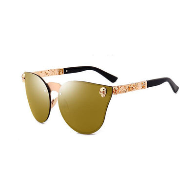 Pink mirrored cat-eye sunglasses with gold-toned frames, skull, and floral embellishments on the temples. - Image 13