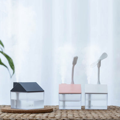 Two house-shaped USB humidifiers, one dark gray and one pink, with clear bases showing H₂O text. - Image 2