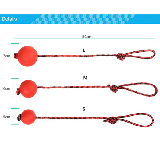 Red rubber dog ball with a red and black braided rope, featuring a knotted loop, on a light brown carpet. - Image 9