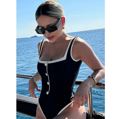 Woman in a white one-piece swimsuit with black trim and decorative buttons, sitting on a boat. - Image 11