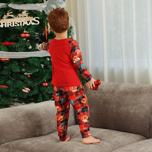 Family matching red Christmas pajamas with a cartoon reindeer and "Merry Christmas" text on a plaid background. - Image 16