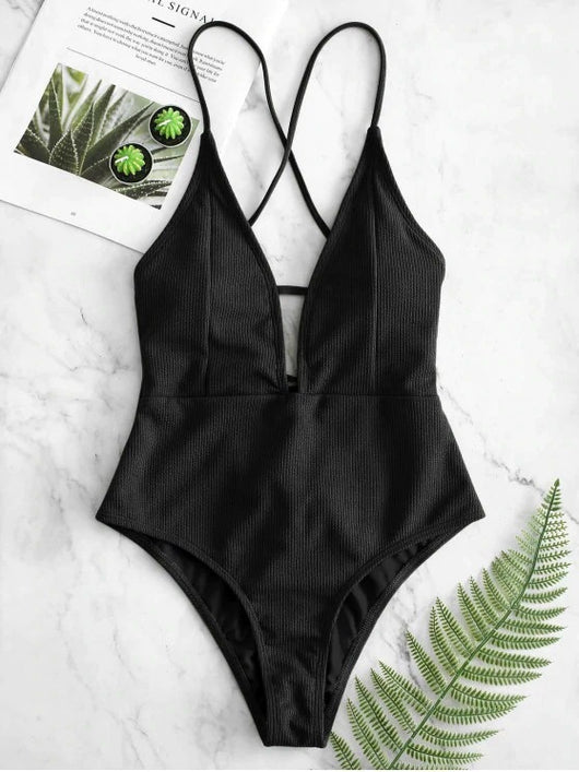 Olive green ribbed one-piece swimsuit with deep V-neck and criss-cross back straps, laid flat on marble. - Image 8