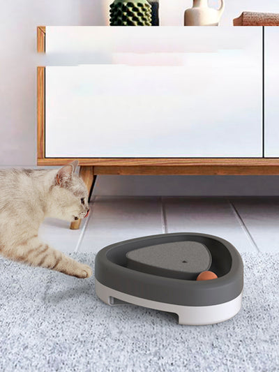 Two-tone green and grey triangle electric cat toy with a rotating feather wand and a ball track on a tiled floor. - Image 3