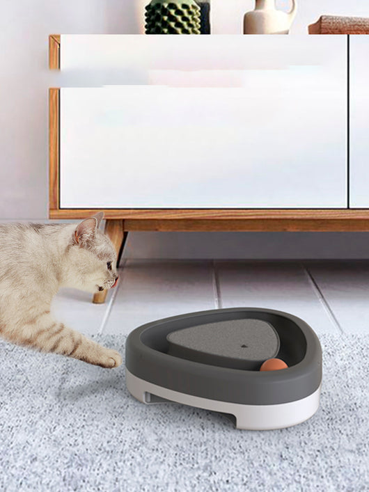 Two-tone green and grey triangle electric cat toy with a rotating feather wand and a ball track on a tiled floor. - Image 3
