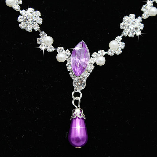 Purple rhinestone and faux pearl necklace and drop earrings set on a black display. Features silver-tone settings. - Image 2