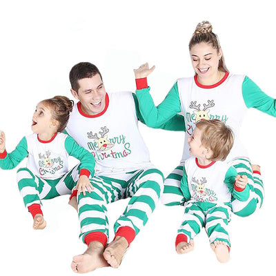 Family of four wearing matching green and white striped Christmas pajamas with a reindeer and "Merry Christmas" text. - Image 3
