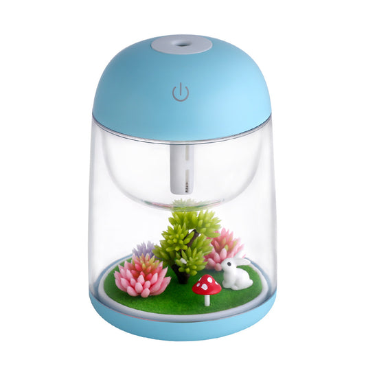 Pink and clear columnar humidifier with a micro landscape inside, featuring a white rabbit, red mushroom, and artificial plants.