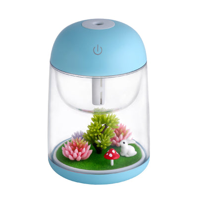Pink and clear columnar humidifier with a micro landscape inside, featuring a white rabbit, red mushroom, and artificial plants.