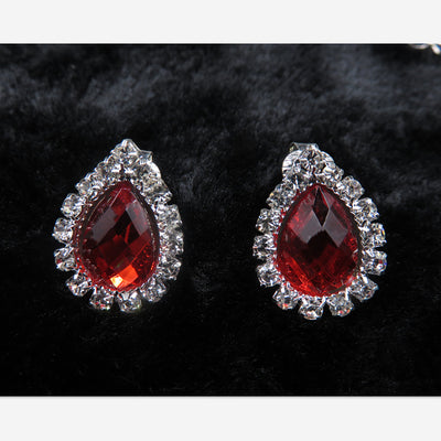 Purple teardrop rhinestone necklace and matching stud earrings set on a black background. - Image 3