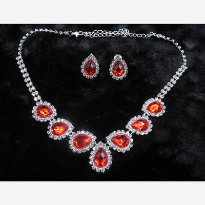 Purple teardrop rhinestone necklace and matching stud earrings set on a black background. - Image 9