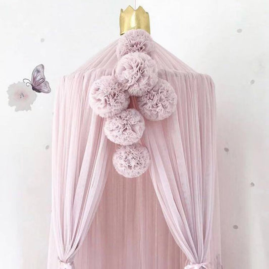 Pink, white, and purple yarn ball pendant party decoration with a fabric tie, ideal for children's rooms.