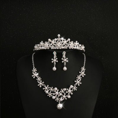 Bridal jewelry set with a silver-tone necklace and matching drop earrings, featuring crystal flowers and faux pearls. - Image 5