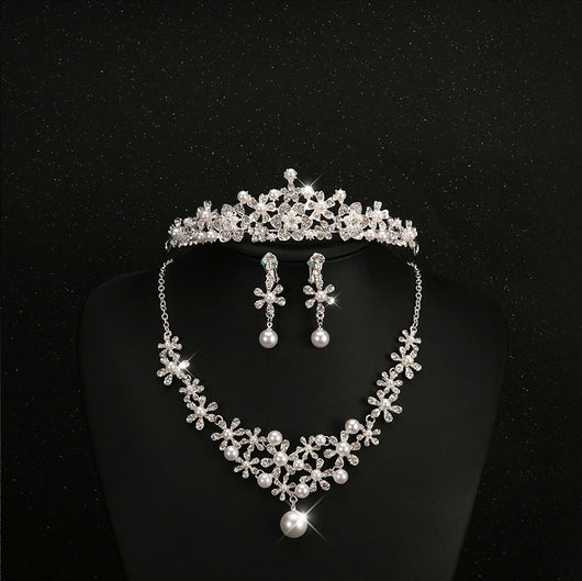Bridal jewelry set with a silver-tone necklace and matching drop earrings, featuring crystal flowers and faux pearls. - Image 5